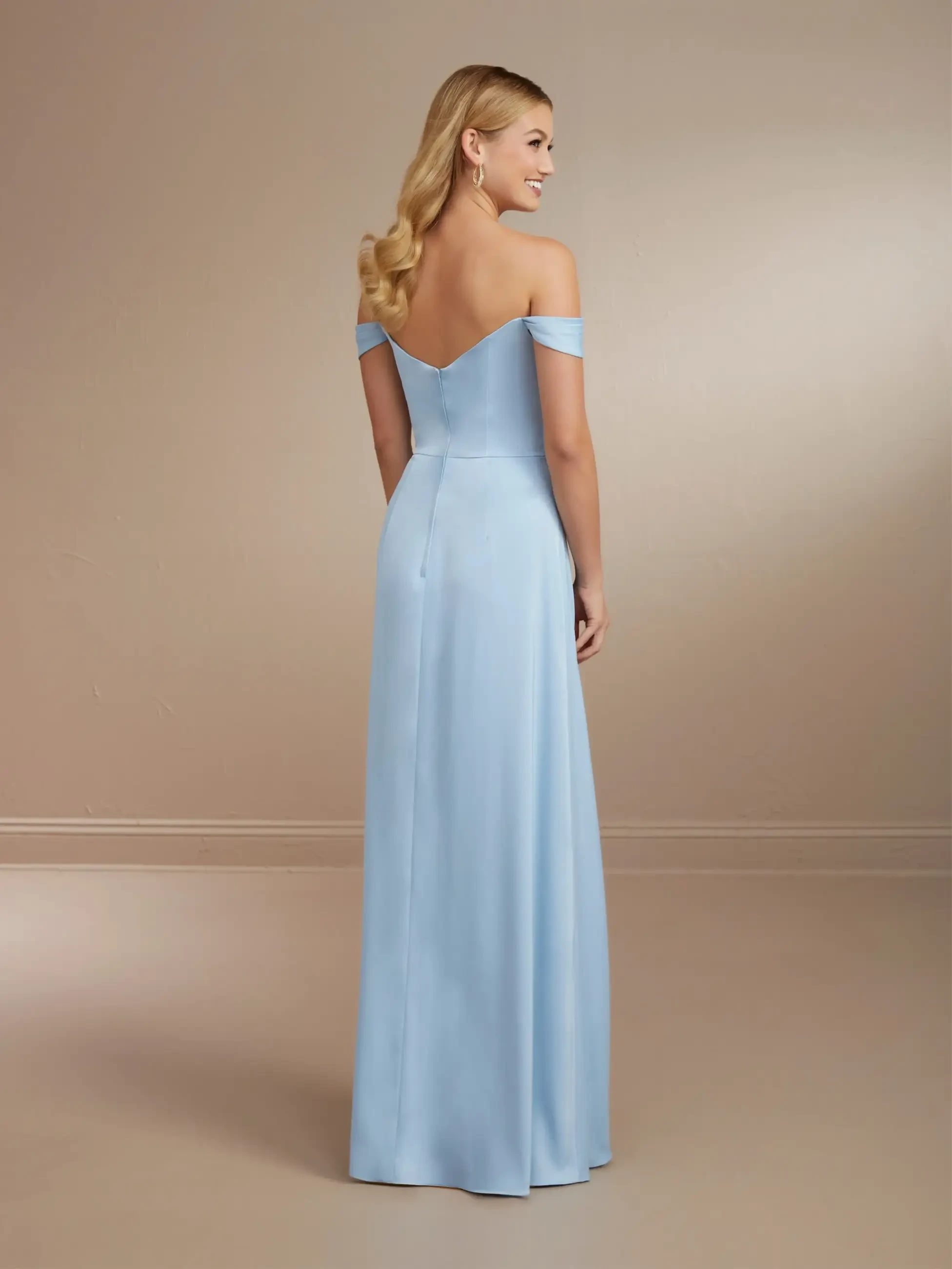 Model is wearing a chiffon off the shoulder sheath bridesmaid dress