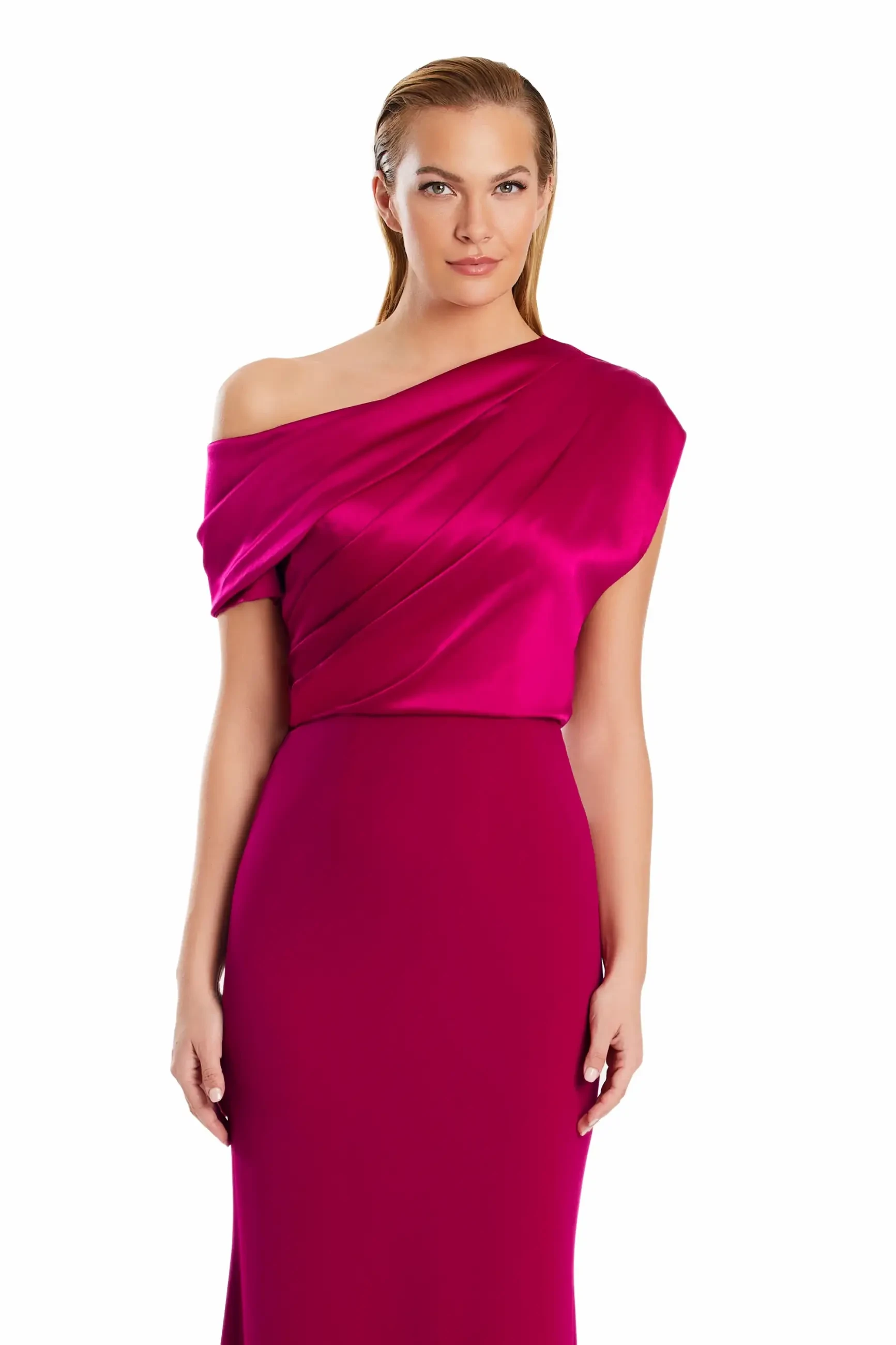 Woman wearing an elegant magenta one-shoulder gown with soft draping, standing confidently against a white background. Poised and stylish appearance.