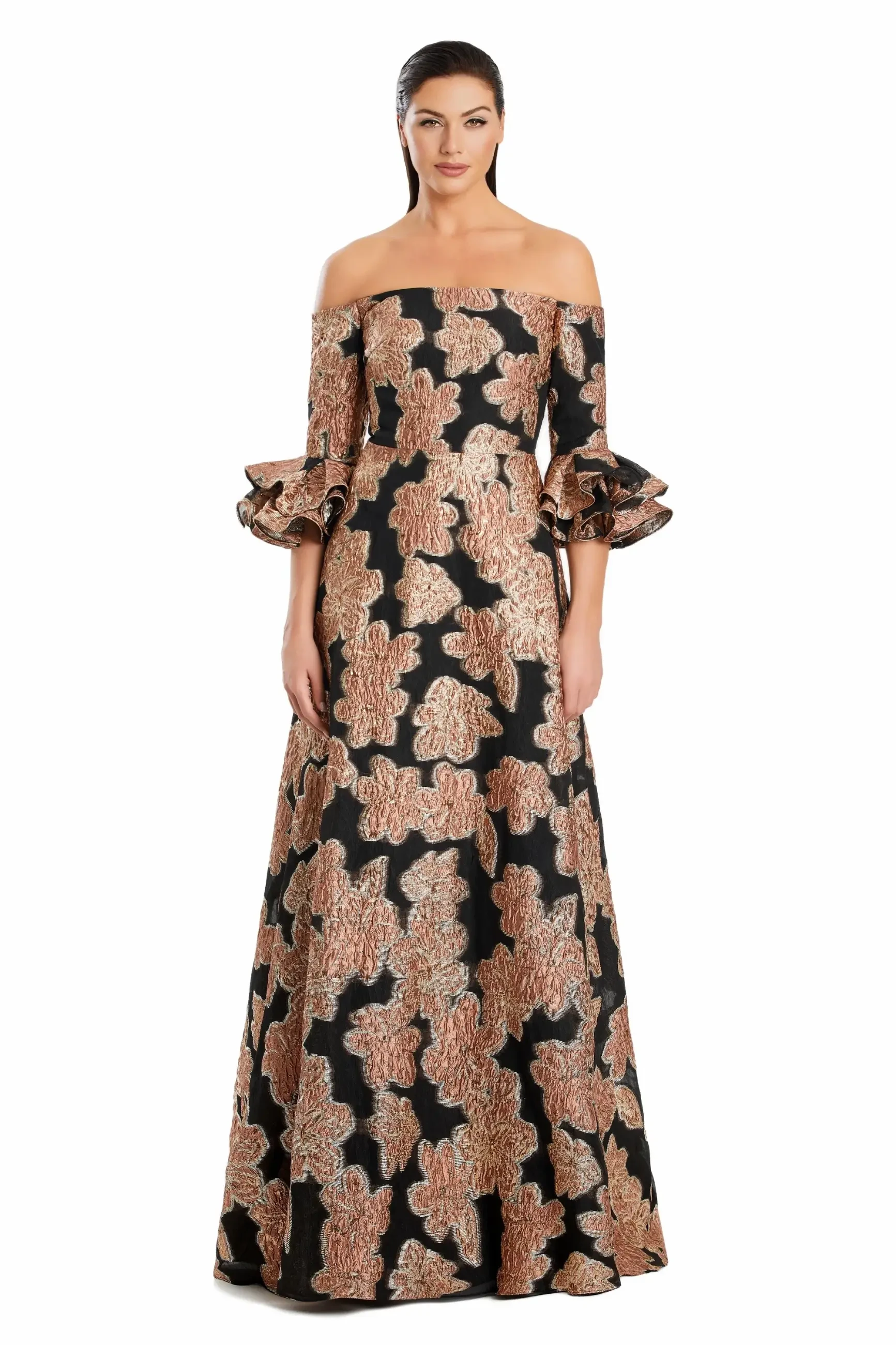 Woman in a long, off-shoulder black gown with gold floral patterns and ruffled sleeves. The expression is confident, conveying elegance and poise.
