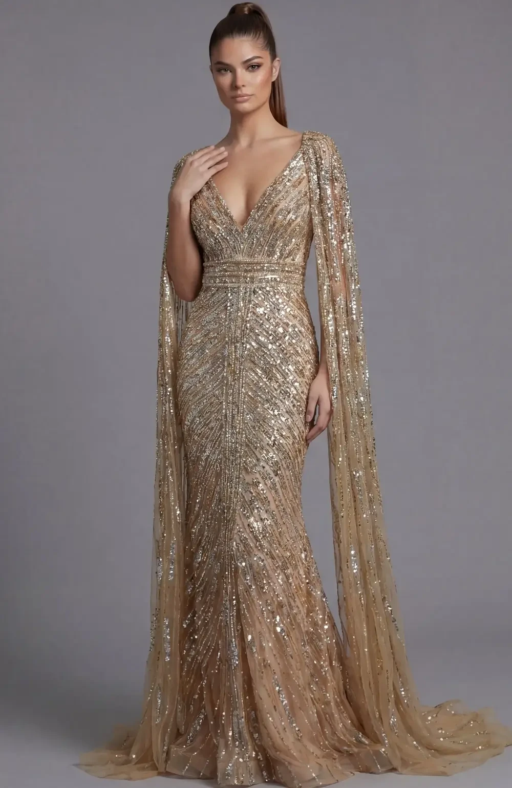 A woman wearing a glamorous, fitted, gold sequin gown with a plunging neckline and a flowing cape-like detail.