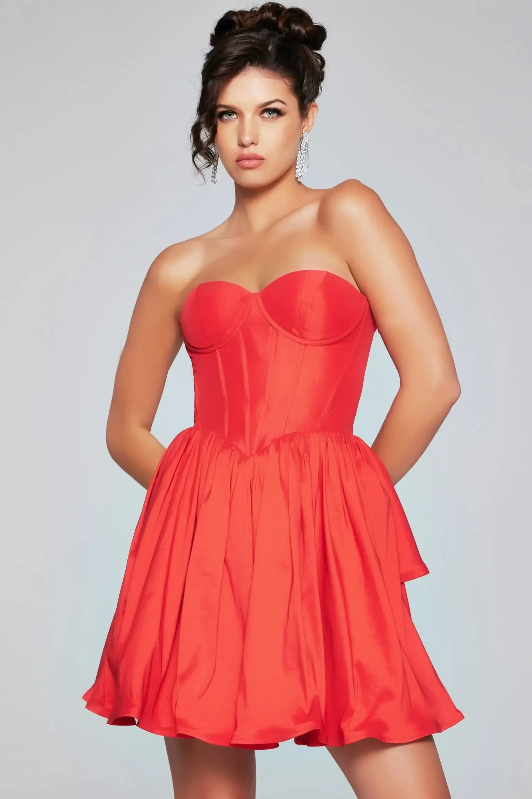model is wearing a strapless basque waist mini homecoming dress