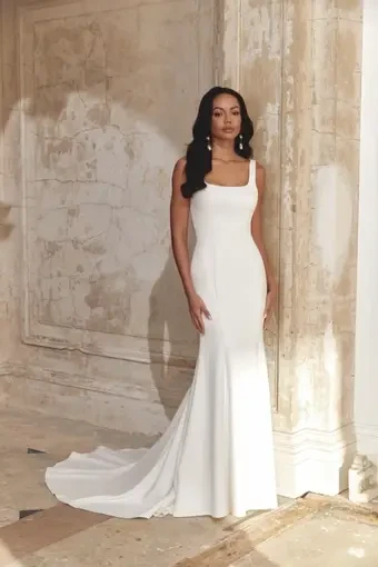 model is wearing a sleeveless minimalist bridal gown