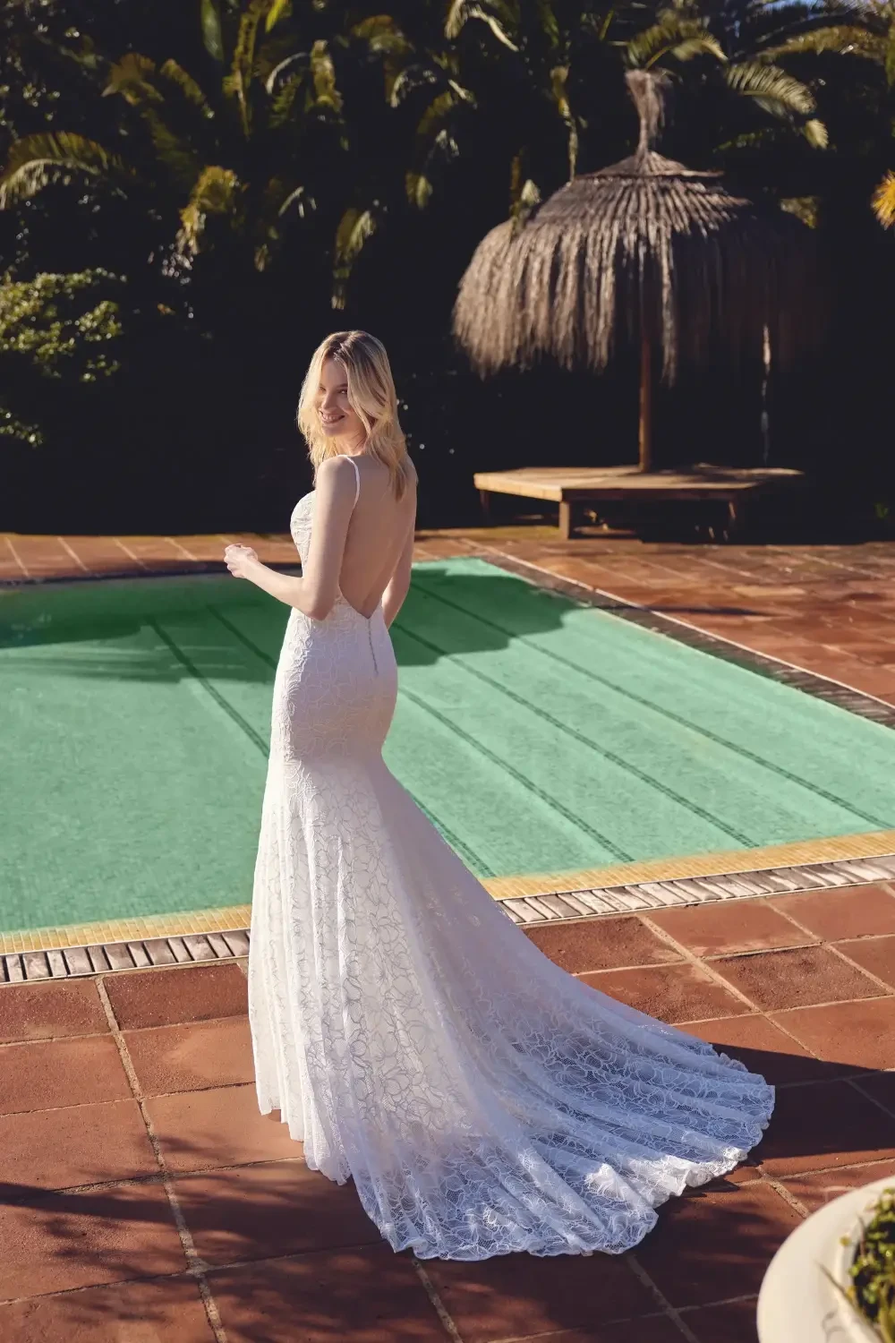 model is wearing a romantic lace bridal gown