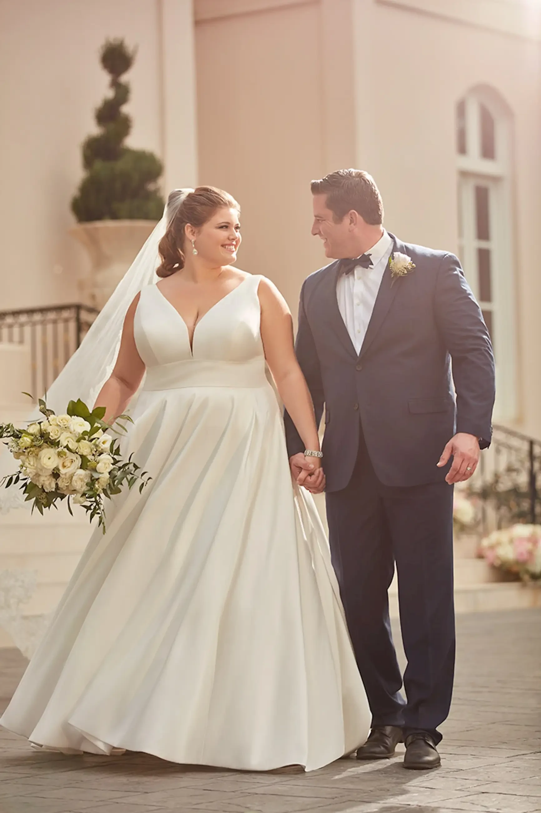 Model is wearing a matte mikado ball gown plus size wedding dress