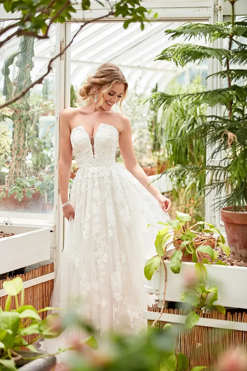 model is wearing a strapless a-line wedding gown