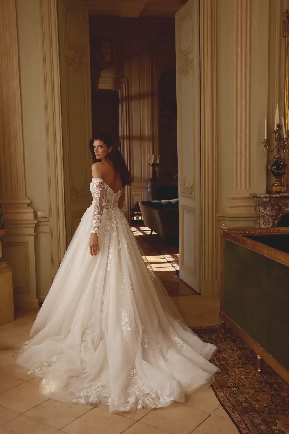 model is wearing an off the shoulder ball gown