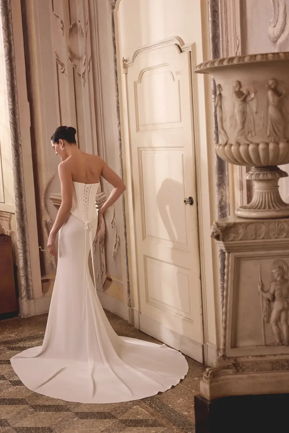 model is wearing a strapless fit and flare bridal gown