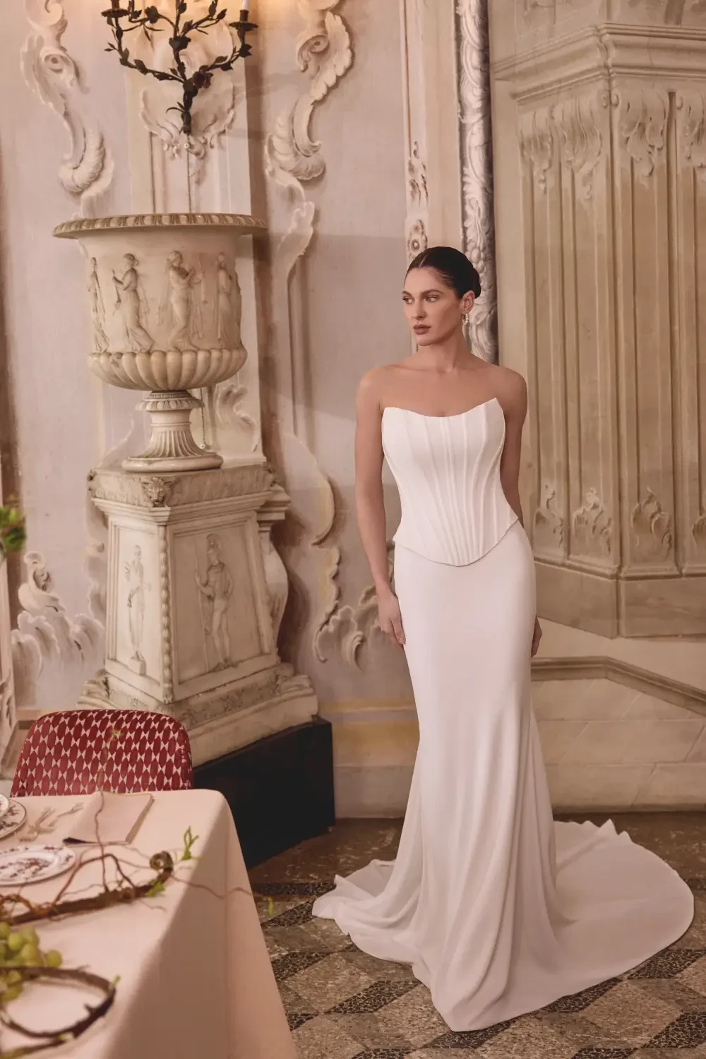 model is wearing a strapless fit and flare bridal gown