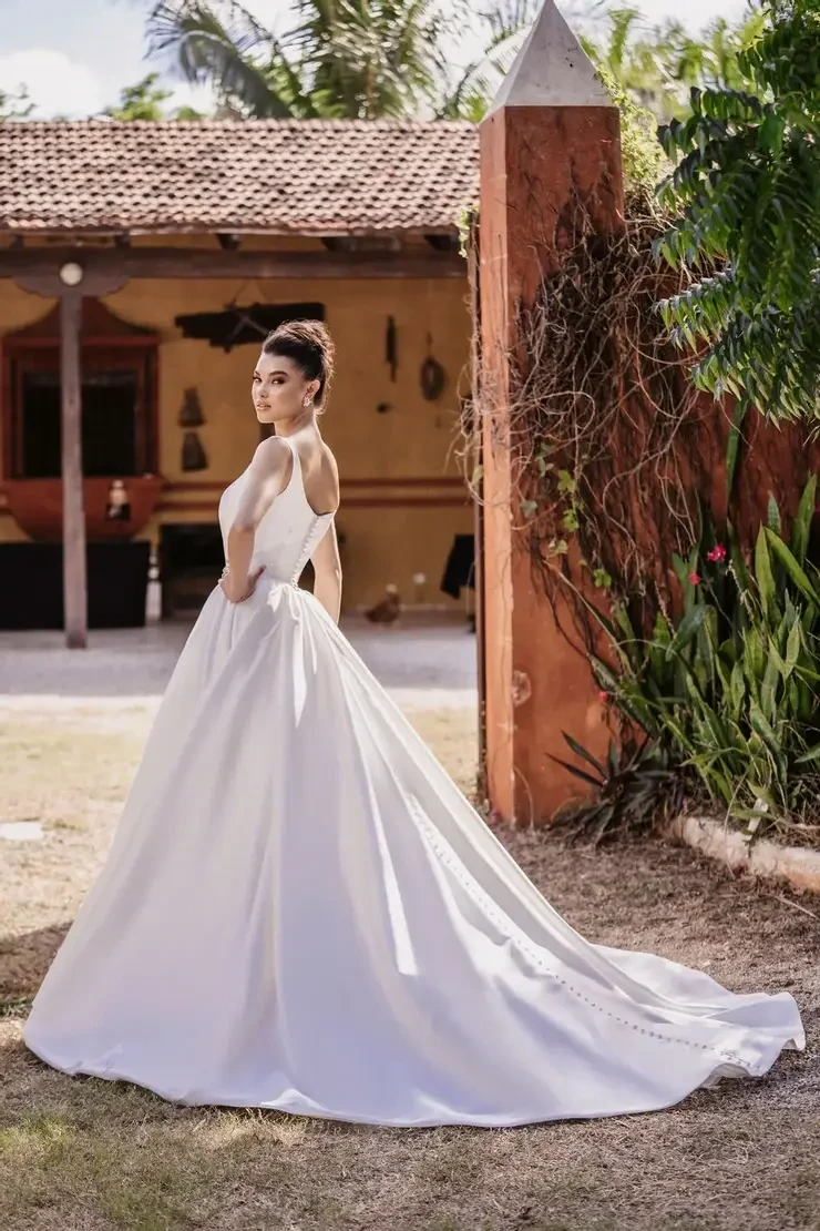 model is wearing a sleek sleeveless a-line wedding dress