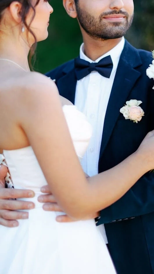 Сouple wearing a white gown and a black suit