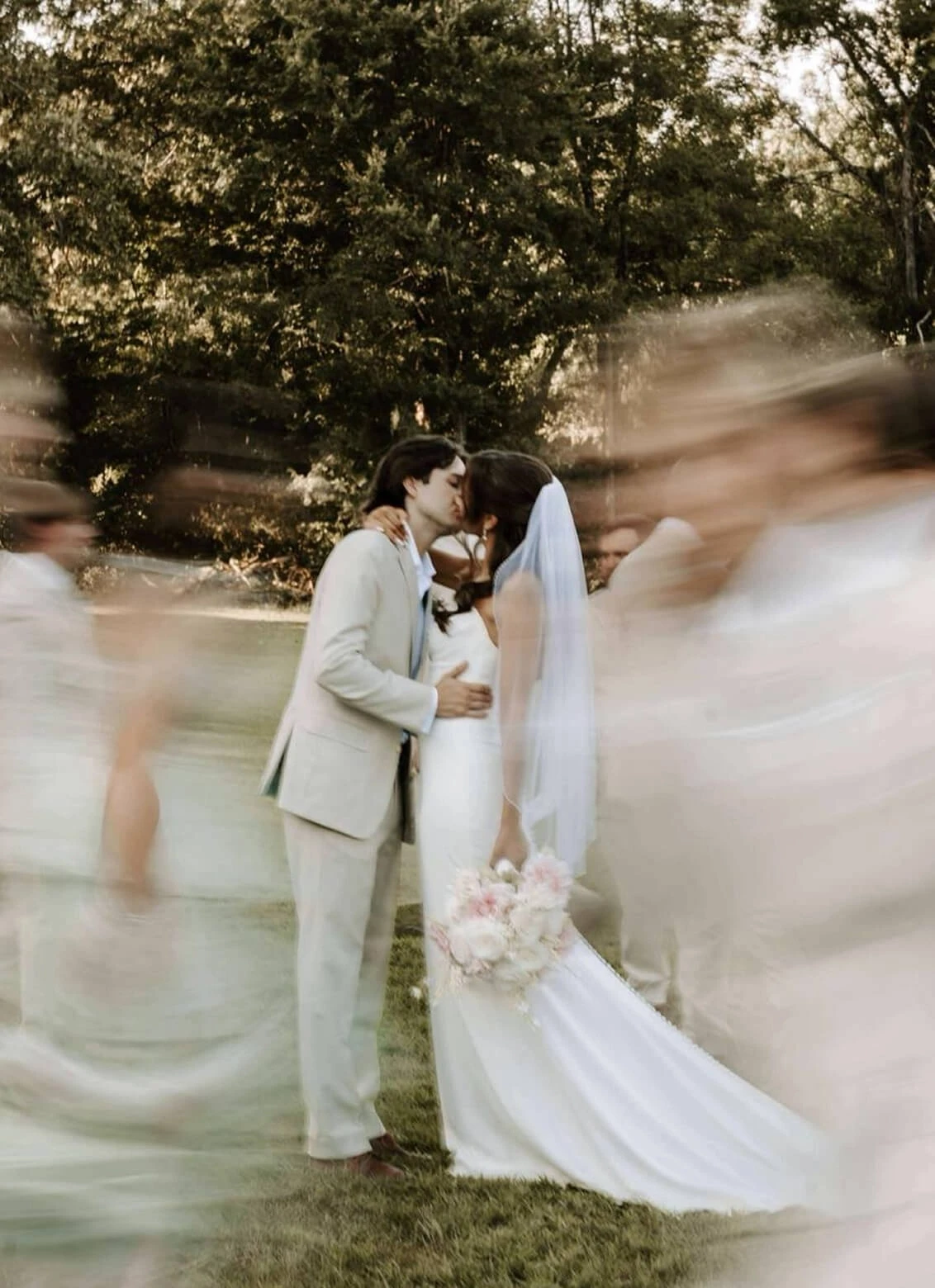 Сouple wearing a white gown and a white suit