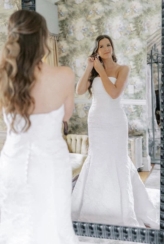 Model wearing a white bridal gown with mirror