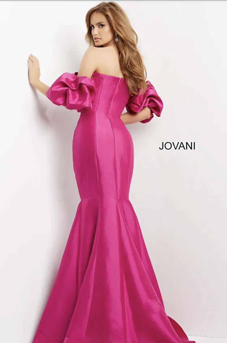 model is wearing an off the shoulder hot pink fit and flare mother of the bride evening gown
