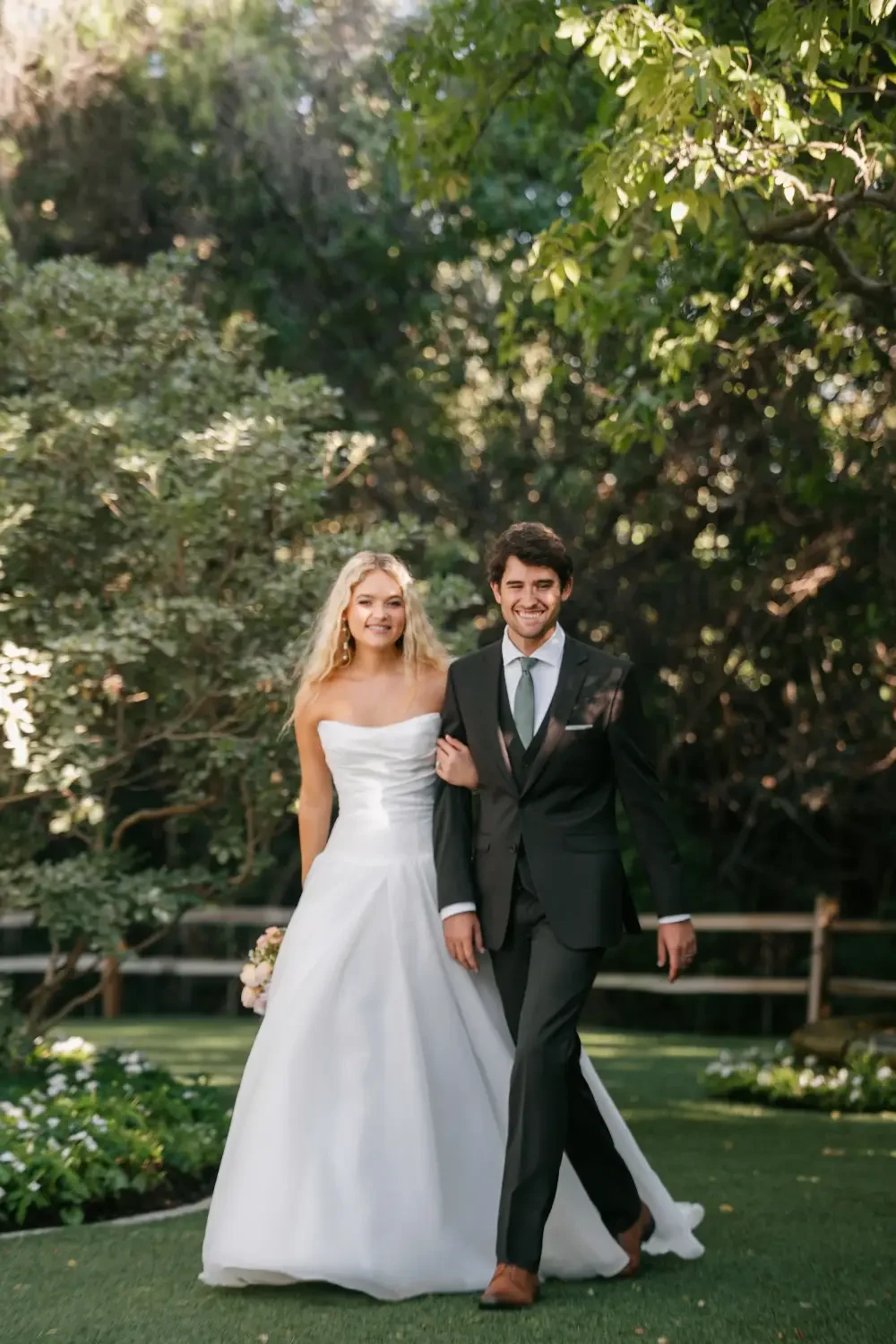 model is wearing a strapless drop waist bridal gown