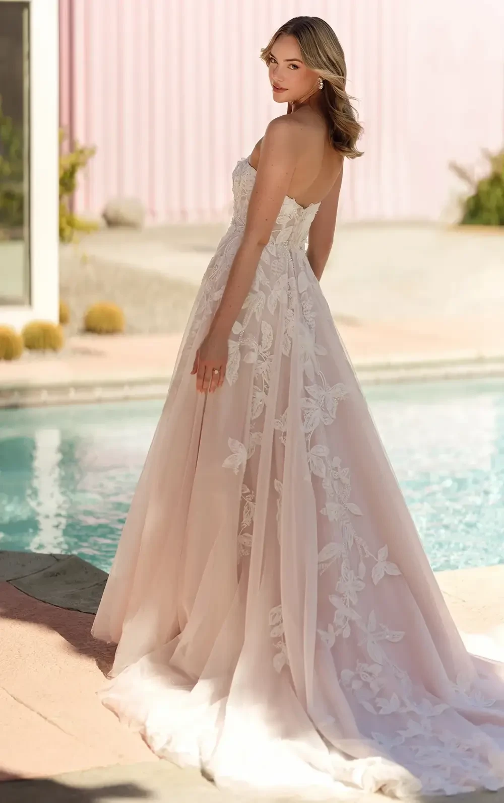 model is wearing a romantic lace bridal gown