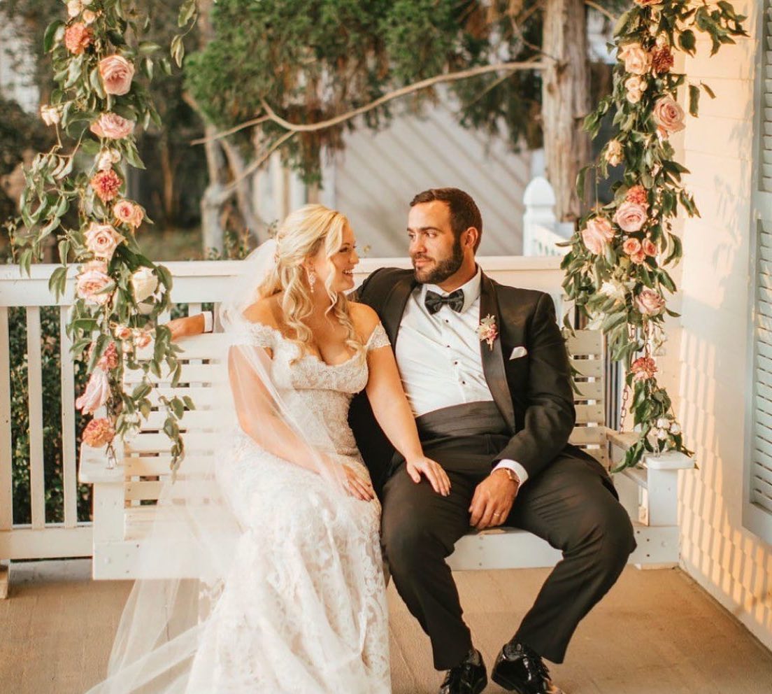 Сouple wearing a white gown and a black suit